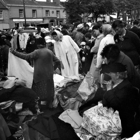 The Old Ones cover: a busy black and white street market